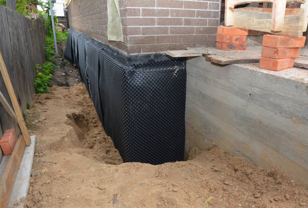 SJ Waterproofing Pros technician performing targeted Wet Basement Repair assessment in Burt, NY